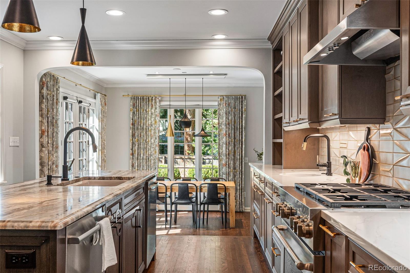 28 Crestmoor Drive Denver, CO 80220 - Photo 16 of 45 a kitchen with granite countertop a stove and a sink