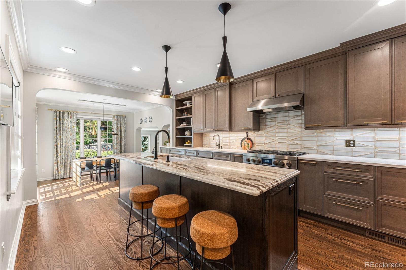 28 Crestmoor Drive Denver, CO 80220 - Photo 17 of 45 a kitchen with stainless steel appliances granite countertop a sink a stove and a wooden floors