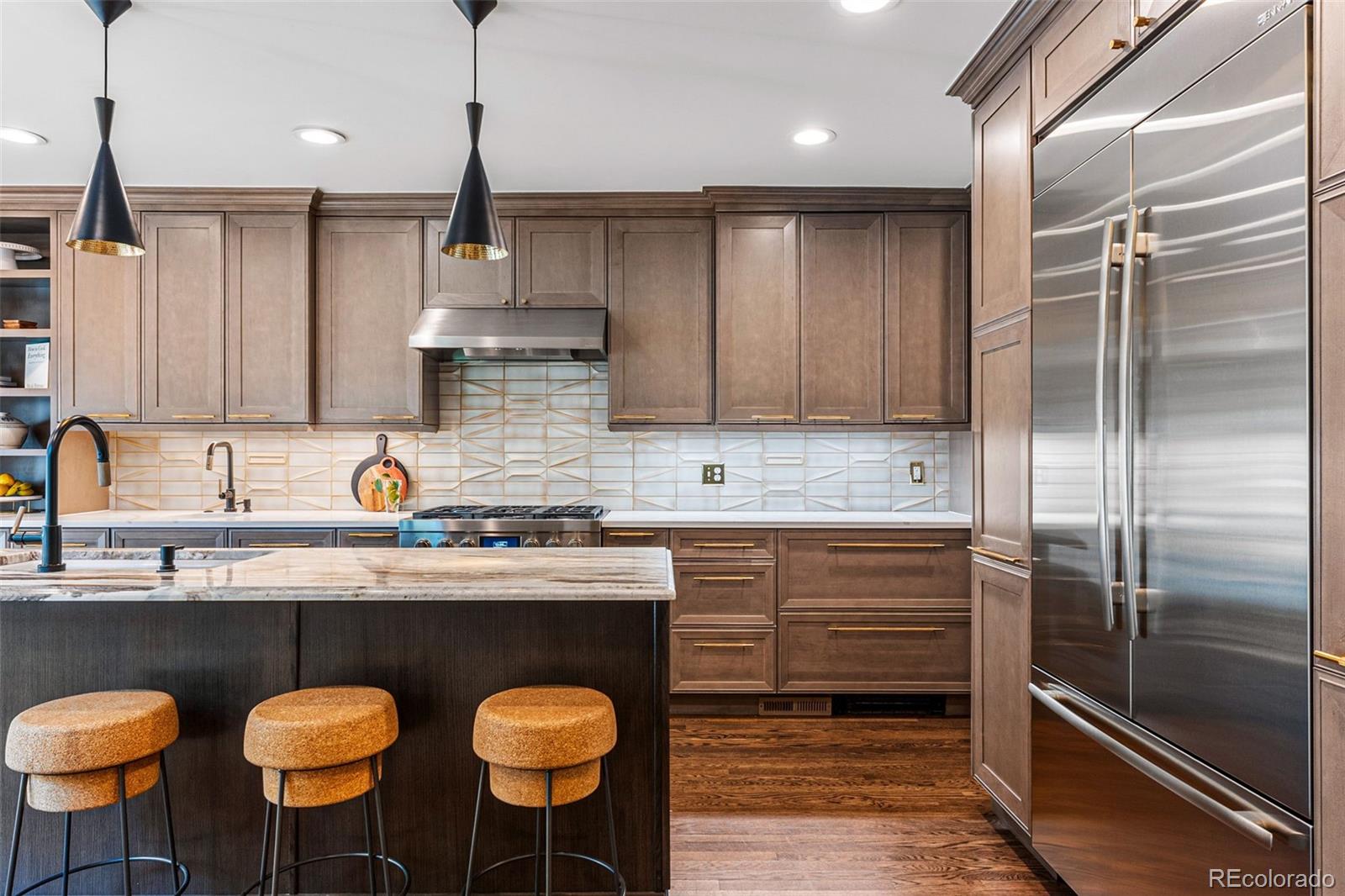 28 Crestmoor Drive Denver, CO 80220 - Photo 18 of 45 a kitchen with stainless steel appliances a sink and a refrigerator