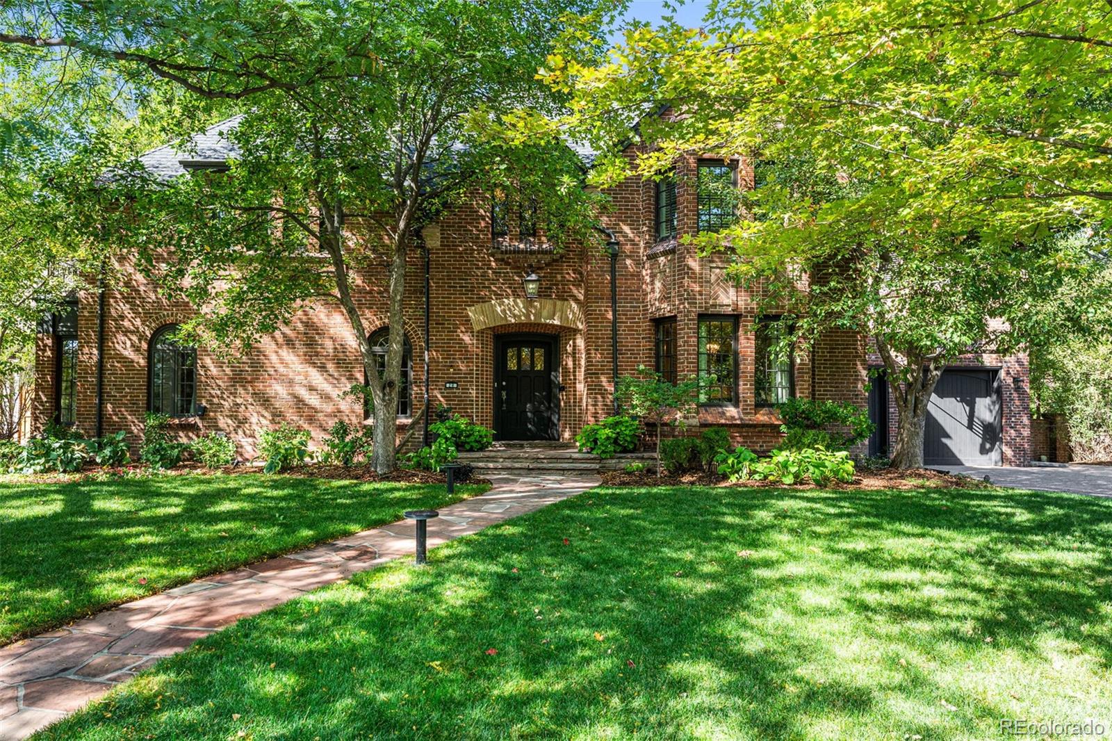 28 Crestmoor Drive Denver, CO 80220 - Photo 2 of 45 a view of a house with a yard and tree s