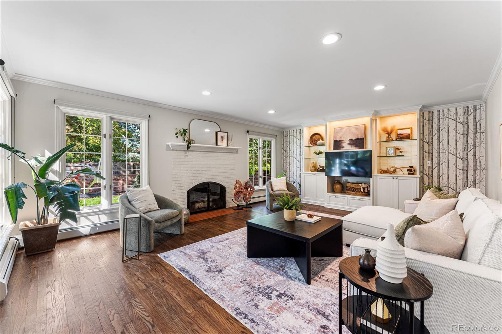 28 Crestmoor Drive Denver, CO 80220 - Photo 21 of 45 a living room with furniture a fireplace and a table