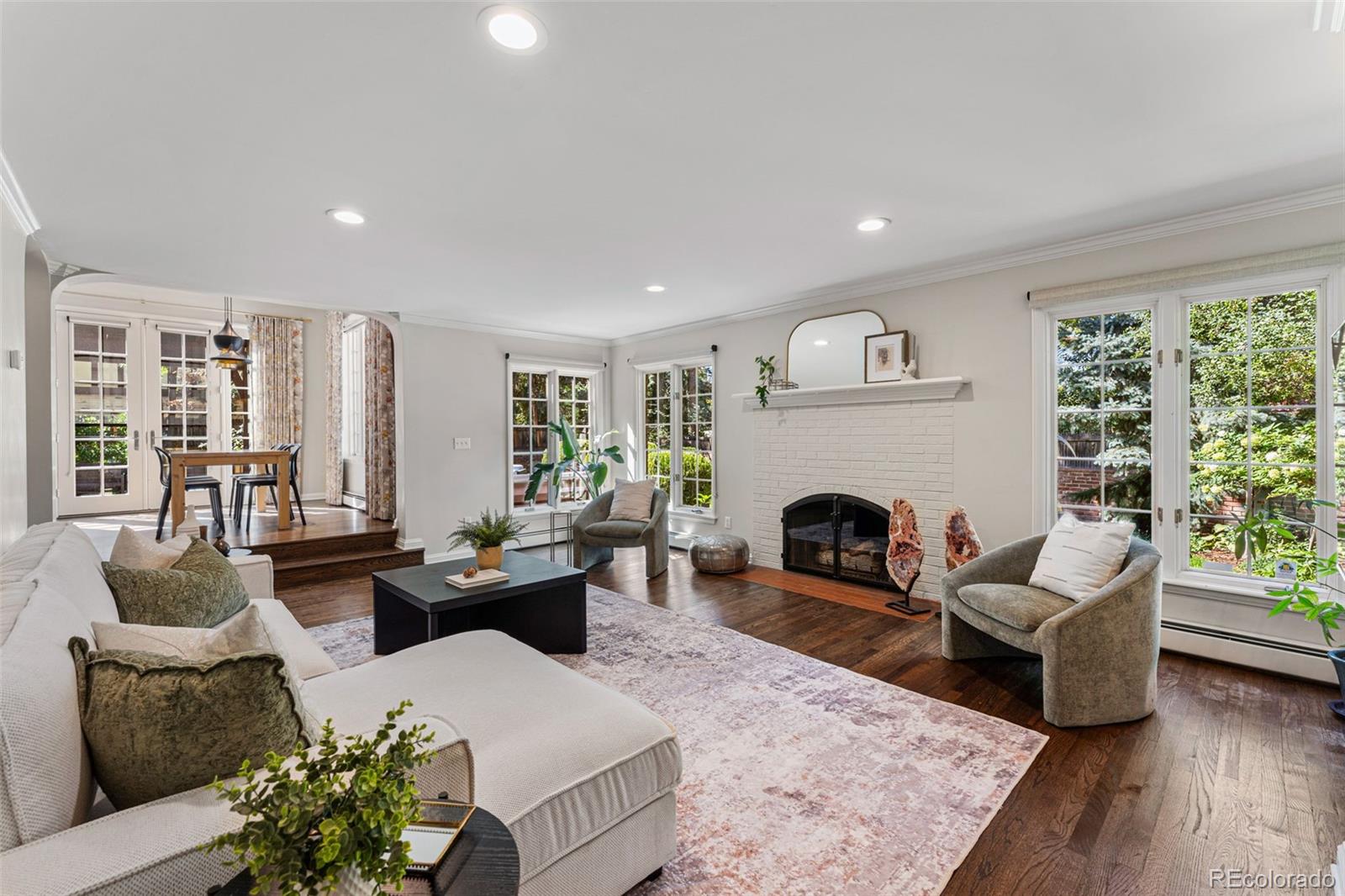 28 Crestmoor Drive Denver, CO 80220 - Photo 22 of 45 a living room with furniture fireplace and potted plants