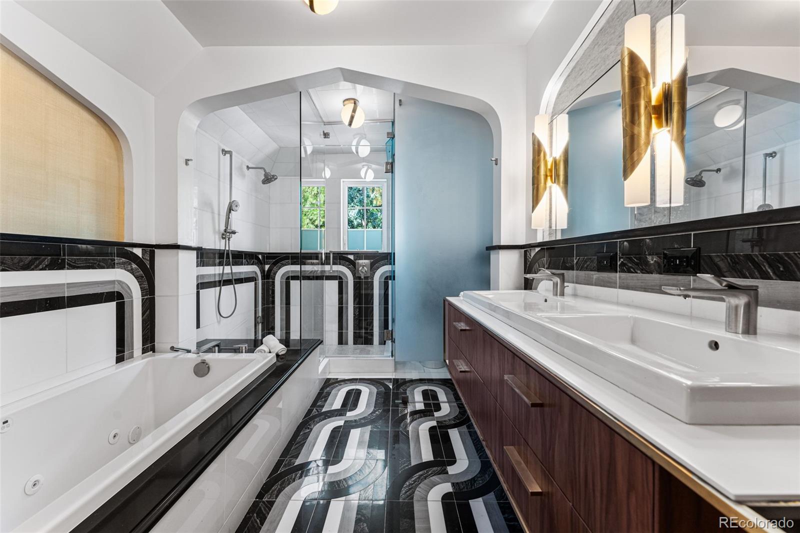 28 Crestmoor Drive Denver, CO 80220 - Photo 27 of 45 a bathroom with a double vanity sink a mirror and a bathtub