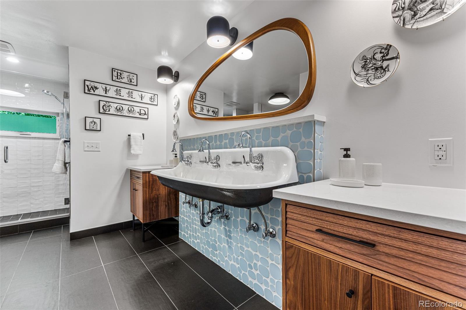 28 Crestmoor Drive Denver, CO 80220 - Photo 33 of 45 a bathroom with a sink a mirror and a toilet