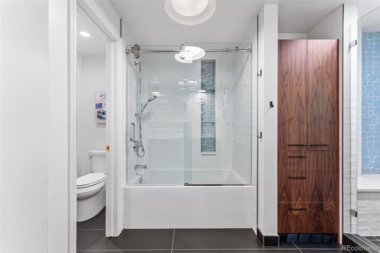 28 Crestmoor Drive Denver, CO 80220 - Photo 34 of 45 a bathroom with a bathtub shower sink and toilet