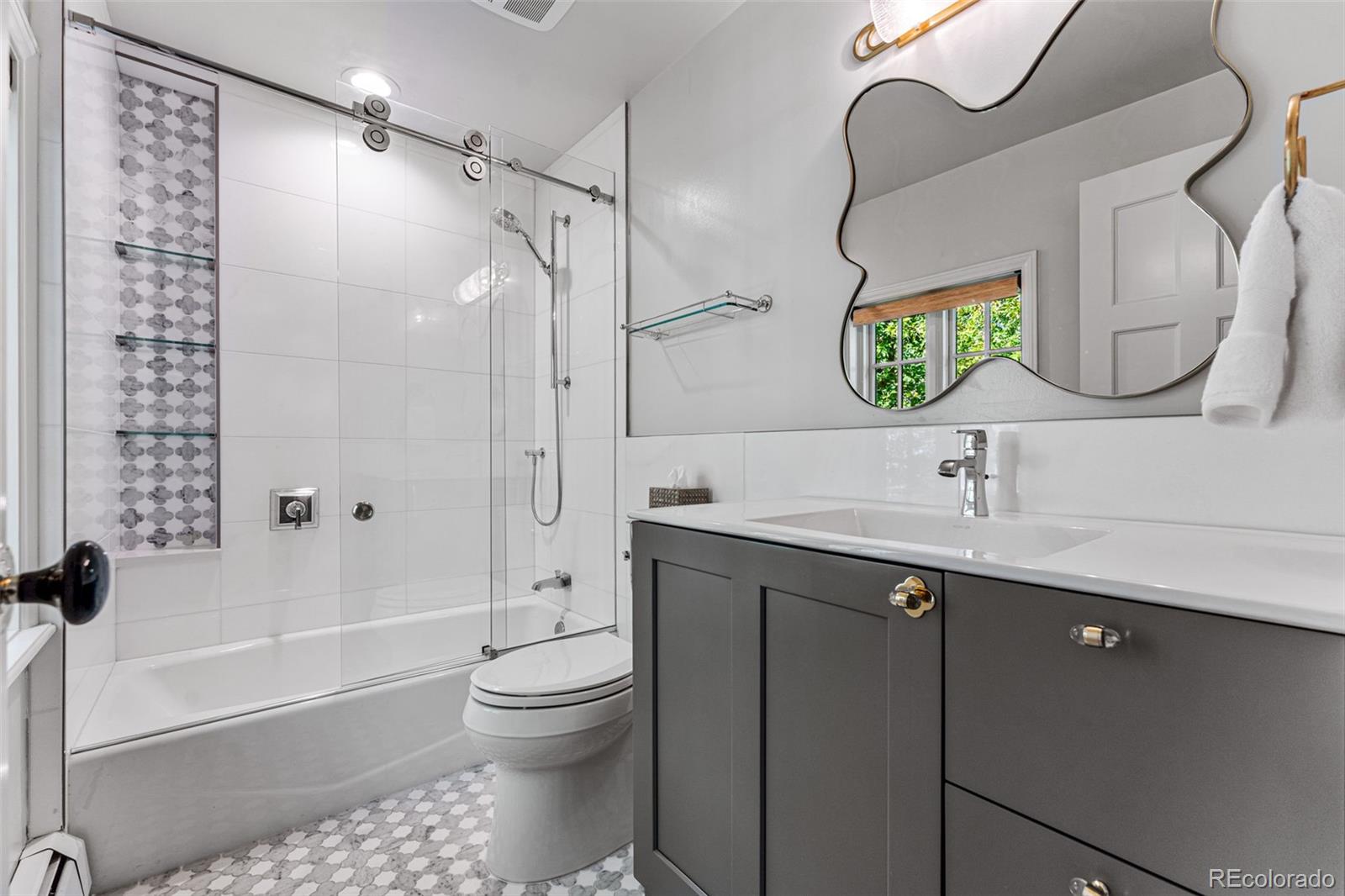 28 Crestmoor Drive Denver, CO 80220 - Photo 36 of 45 a bathroom with a sink a toilet and shower