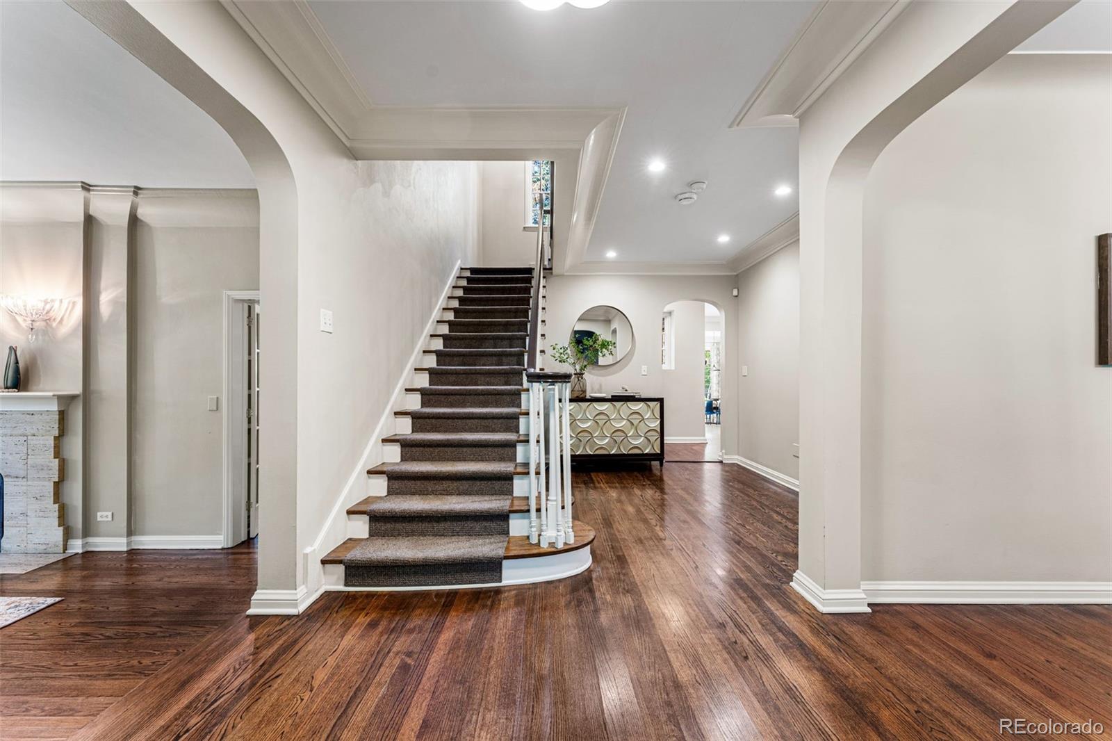 28 Crestmoor Drive Denver, CO 80220 - Photo 4 of 45 a view of a hallway with wooden floor and stairs