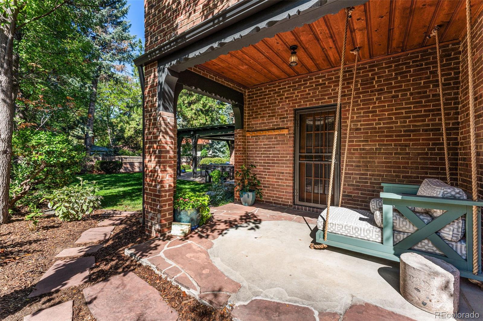 28 Crestmoor Drive Denver, CO 80220 - Photo 44 of 45 a balcony with table and chairs and potted plants