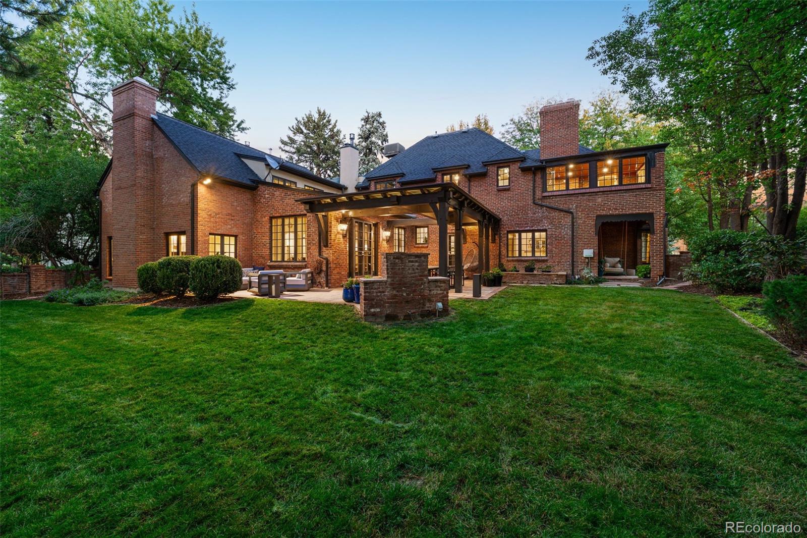 28 Crestmoor Drive Denver, CO 80220 - Photo 45 of 45 a front view of a house with a garden and trees