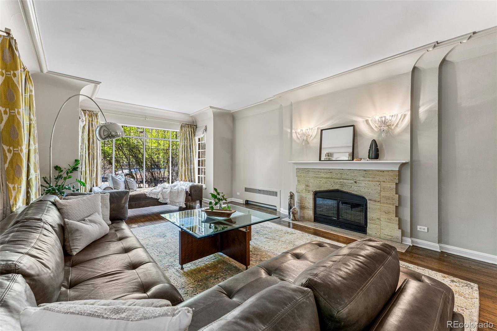 28 Crestmoor Drive Denver, CO 80220 - Photo 7 of 45 a living room with furniture and a fireplace