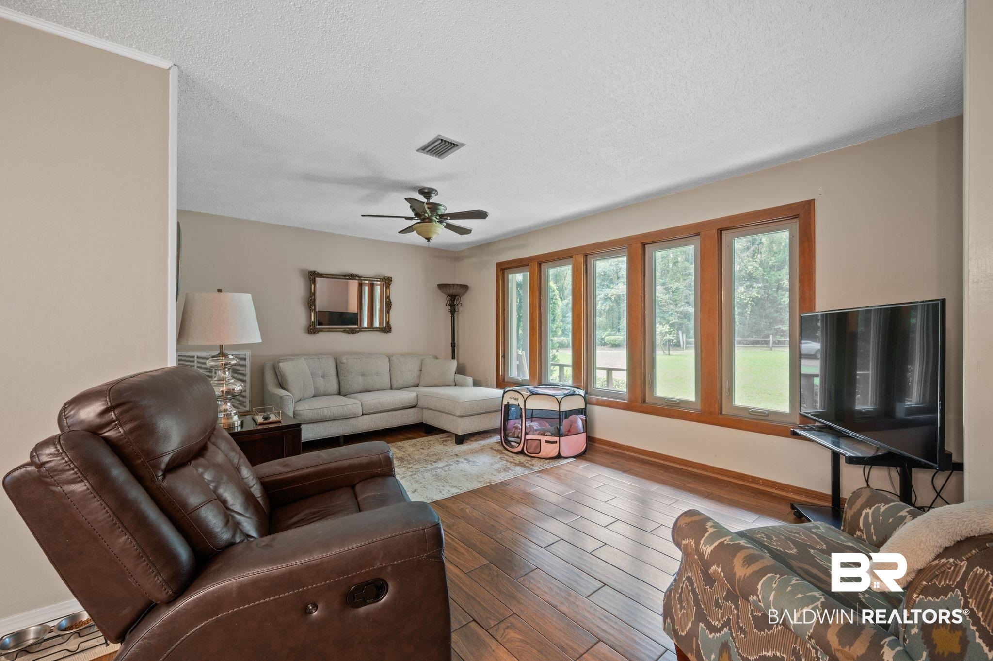 4566 McCrary Road, Unit A Semmes, AL 36575 - Photo 11 of 28 Living room with hardwood / wood-style floors, ceiling fan, and a textured ceiling