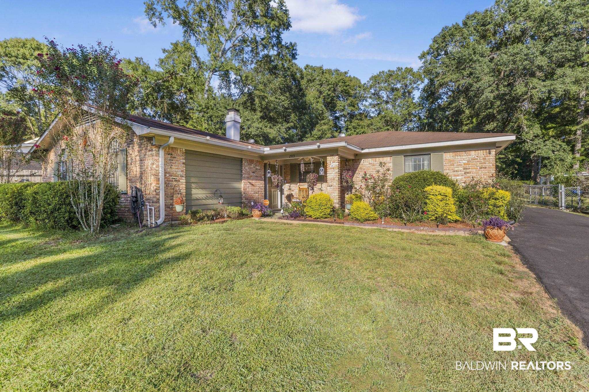 2573 E Road Mobile, AL 36693 - Photo 37 of 45 Ranch-style home with brick siding, a front lawn, and a chimney