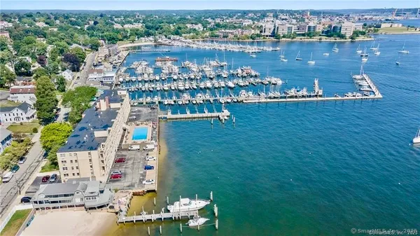 an aerial view of a house with a garden and lake view