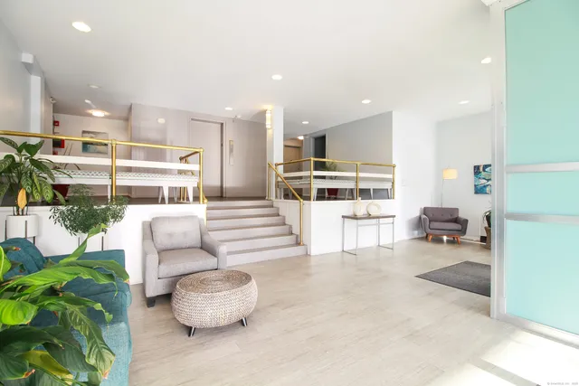 a living room with furniture and a view of kitchen