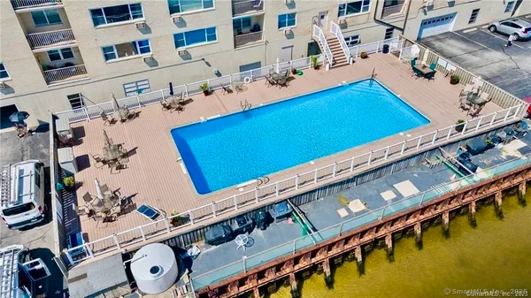 a view of a pool with seating area
