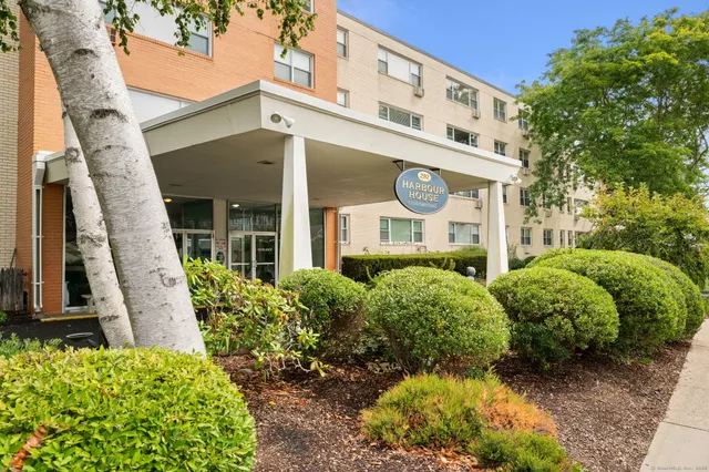 front view of a house with a garden