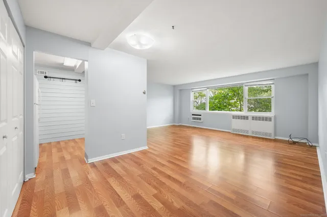 wooden floor in an empty room with a window
