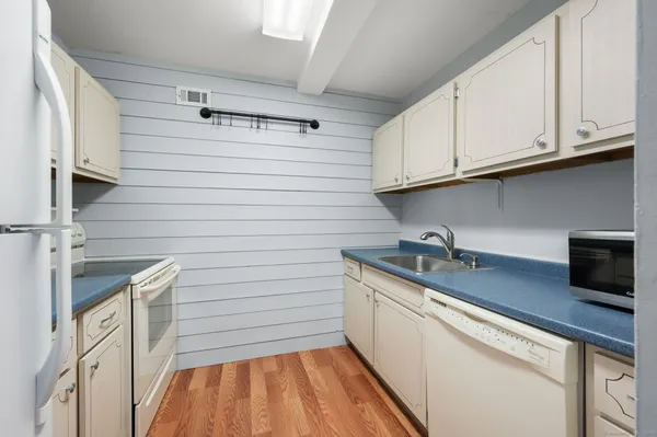 a kitchen with stainless steel appliances granite countertop a sink and a stove