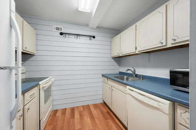 a kitchen with stainless steel appliances granite countertop a sink and a stove