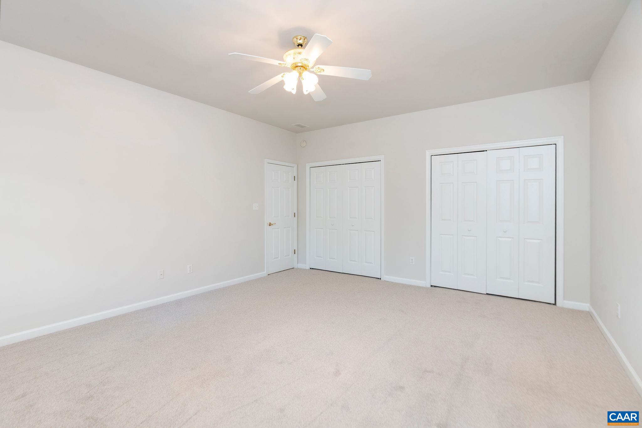 21 Amethyst Road Palmyra, VA 22963 - Photo 39 of 66 an empty room with a chandelier fan and windows