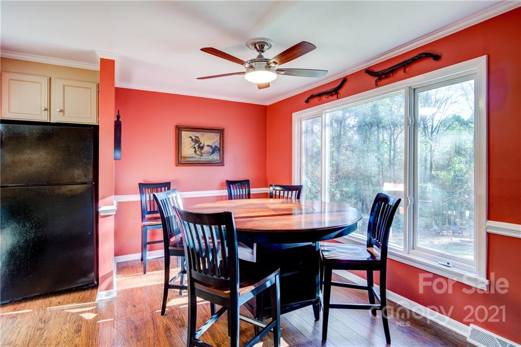 9224 State Rd S-29-624 Indian Land, SC 29707 - Photo 14 of 48 a dining room with furniture a floor to ceiling window and a fireplace