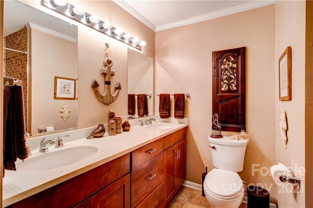 9224 State Rd S-29-624 Indian Land, SC 29707 - Photo 16 of 48 a bathroom with a sink a toilet a mirror and shower