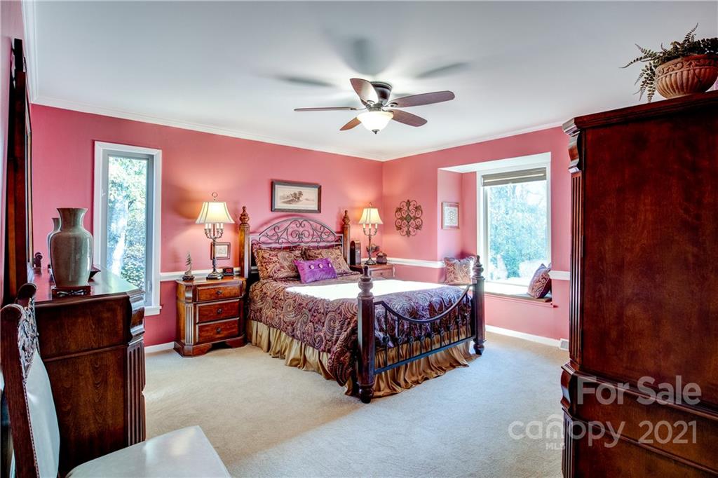 9224 State Rd S-29-624 Indian Land, SC 29707 - Photo 18 of 48 a bedroom with a bed couch chandelier and a window