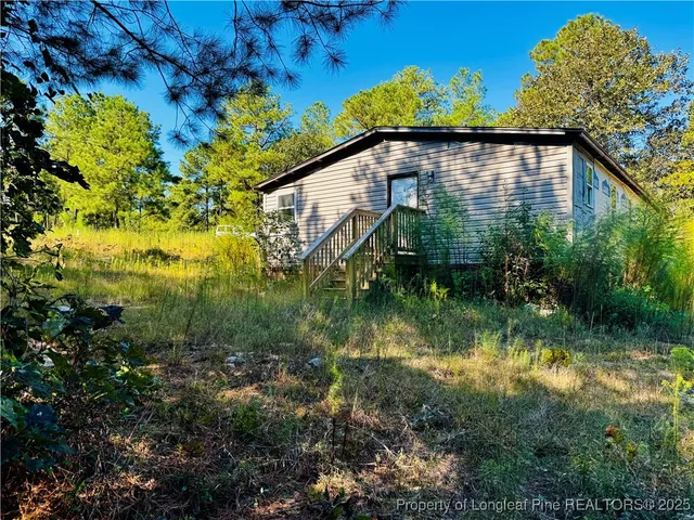 a backyard of a house with lots of green space