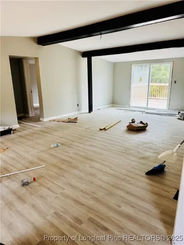 a view of a livingroom with furniture and a window