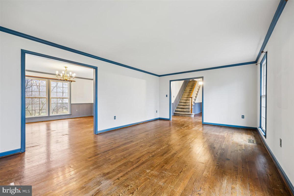 13724 Bridgewater Drive Silver Spring, MD 20904 - Photo 14 of 99 a view of an empty room with wooden floor and a window