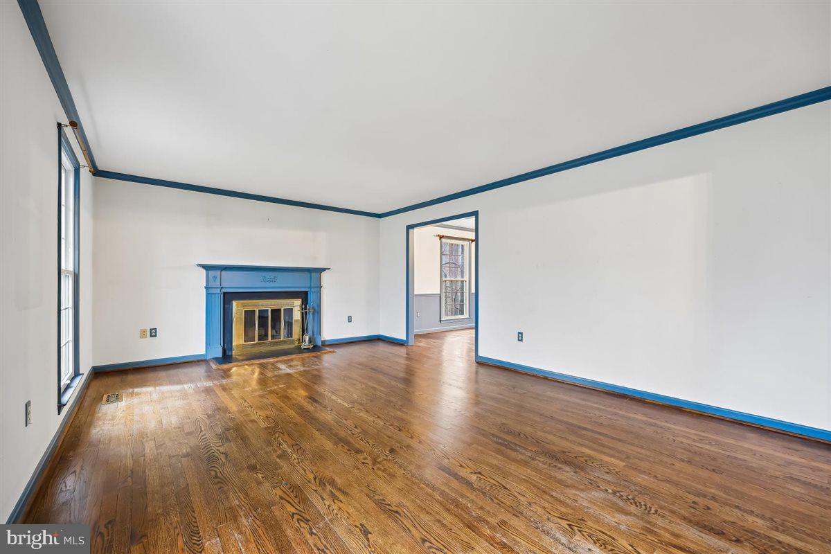13724 Bridgewater Drive Silver Spring, MD 20904 - Photo 15 of 99 a view of empty room with wooden floor and fireplace