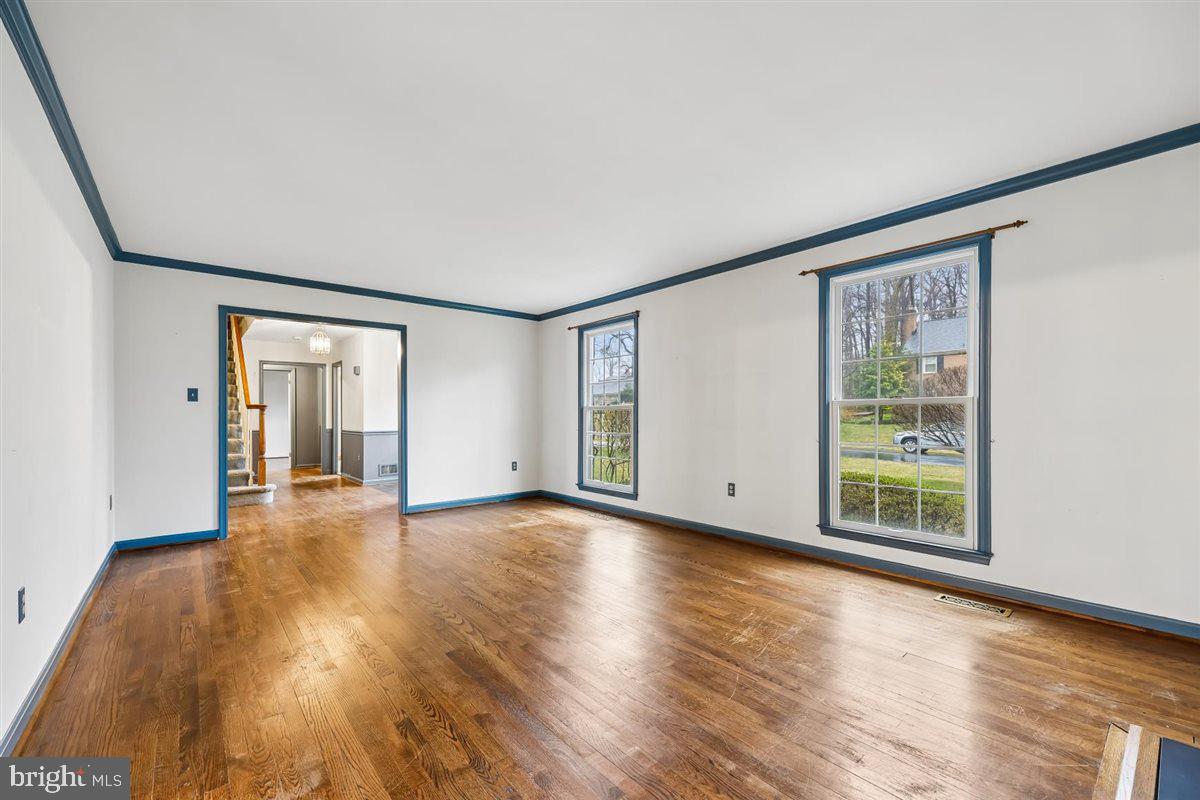 13724 Bridgewater Drive Silver Spring, MD 20904 - Photo 16 of 99 a view of an empty room with wooden floor and a window