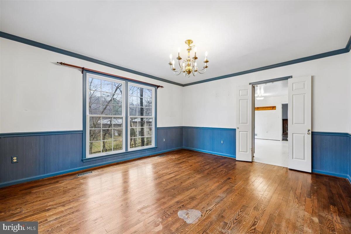 13724 Bridgewater Drive Silver Spring, MD 20904 - Photo 19 of 99 a view of an empty room with wooden floor and a window