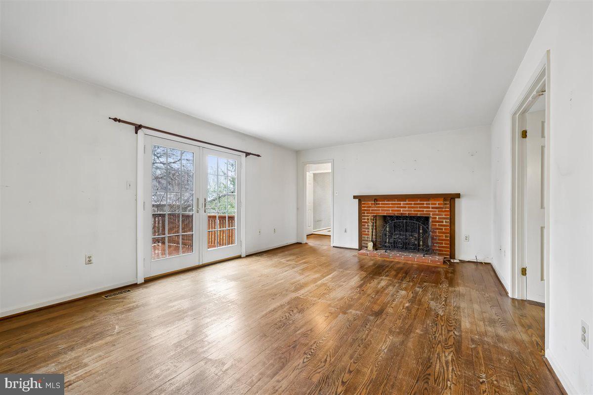 13724 Bridgewater Drive Silver Spring, MD 20904 - Photo 35 of 99 a view of an empty room with a fireplace and a window