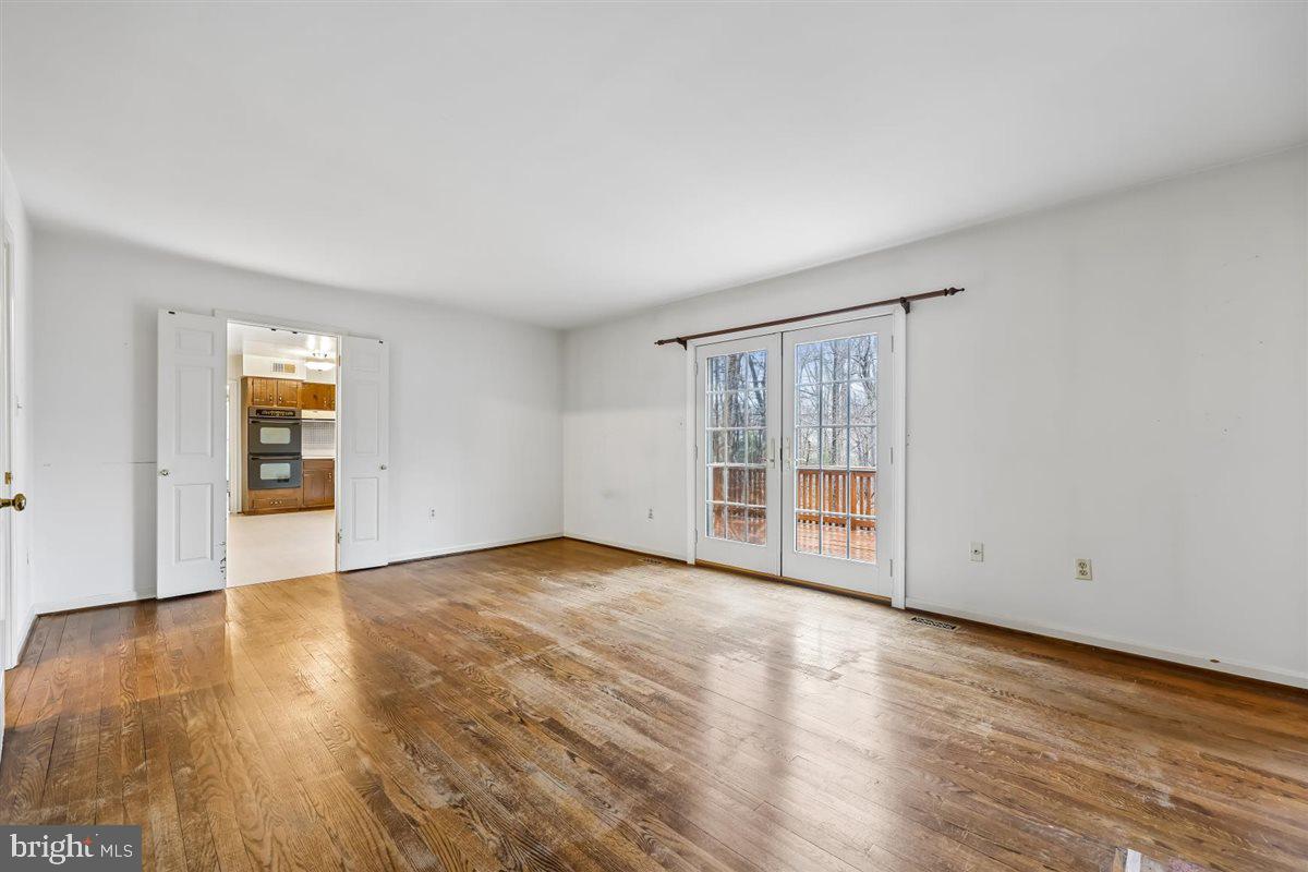 13724 Bridgewater Drive Silver Spring, MD 20904 - Photo 37 of 99 a view of an empty room with wooden floor and a window