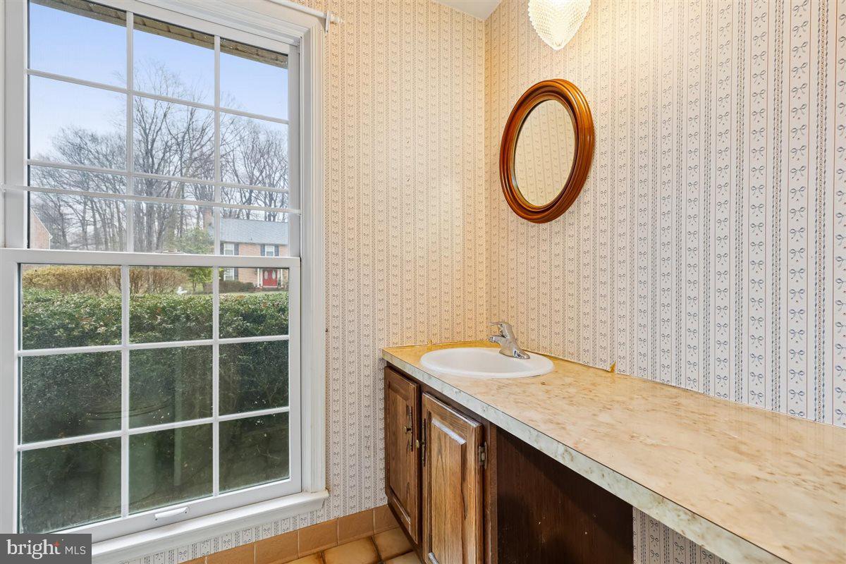 13724 Bridgewater Drive Silver Spring, MD 20904 - Photo 47 of 99 a bathroom with a granite countertop sink and a window