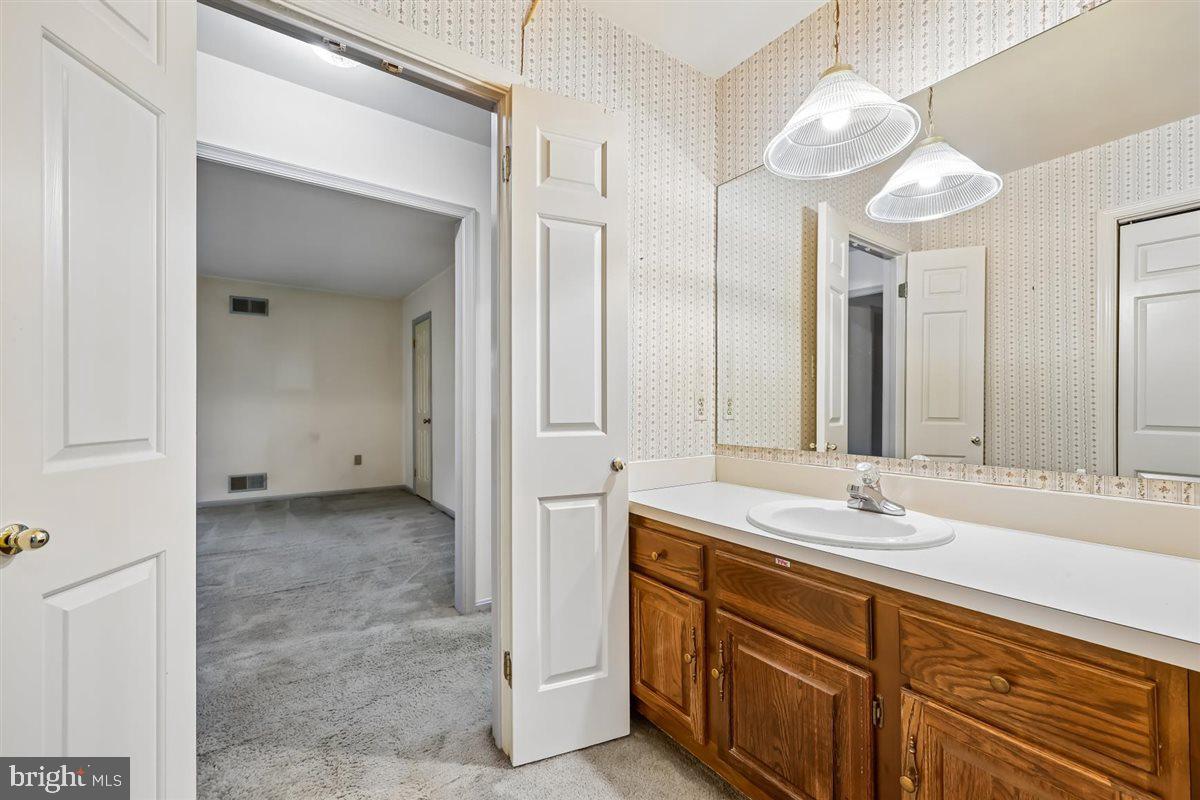 13724 Bridgewater Drive Silver Spring, MD 20904 - Photo 64 of 99 a spacious bathroom with a granite countertop sink a mirror and a shower