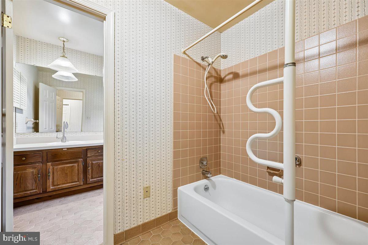 13724 Bridgewater Drive Silver Spring, MD 20904 - Photo 68 of 99 a bathroom with a tub a sink and a mirror