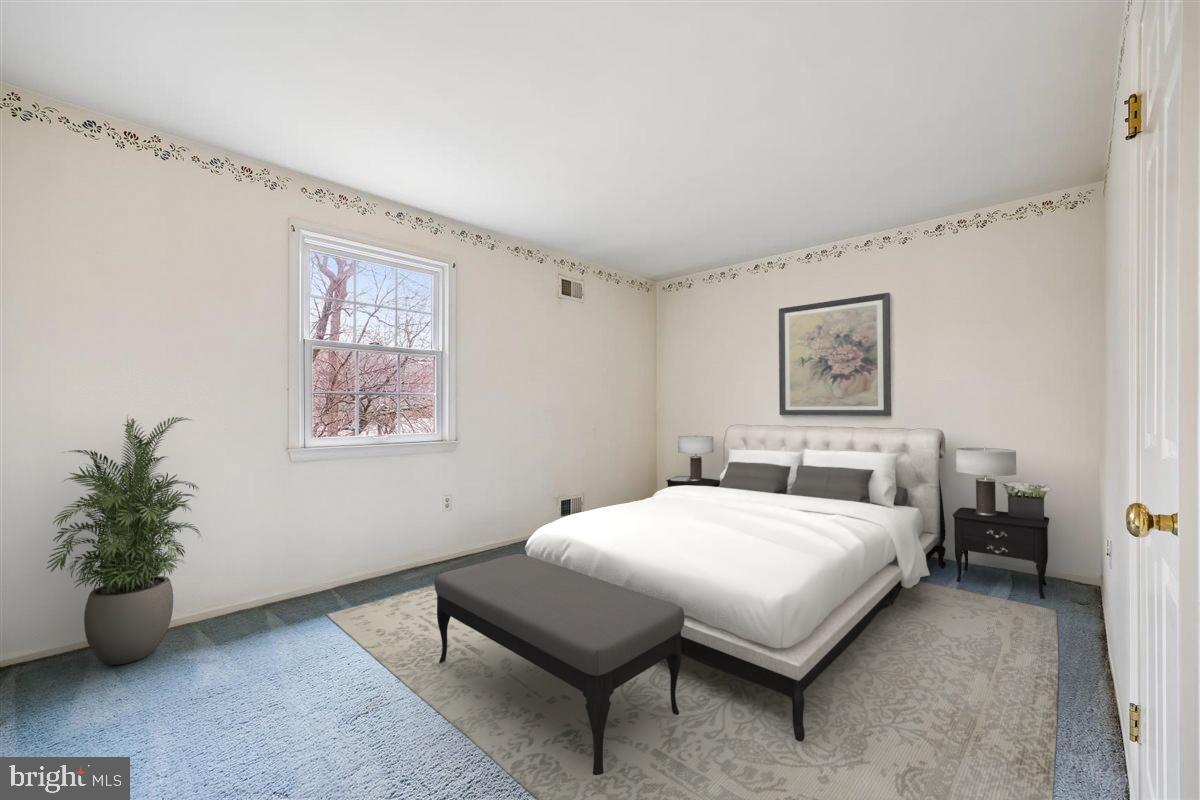 13724 Bridgewater Drive Silver Spring, MD 20904 - Photo 74 of 99 a bedroom with a bed and a potted plant