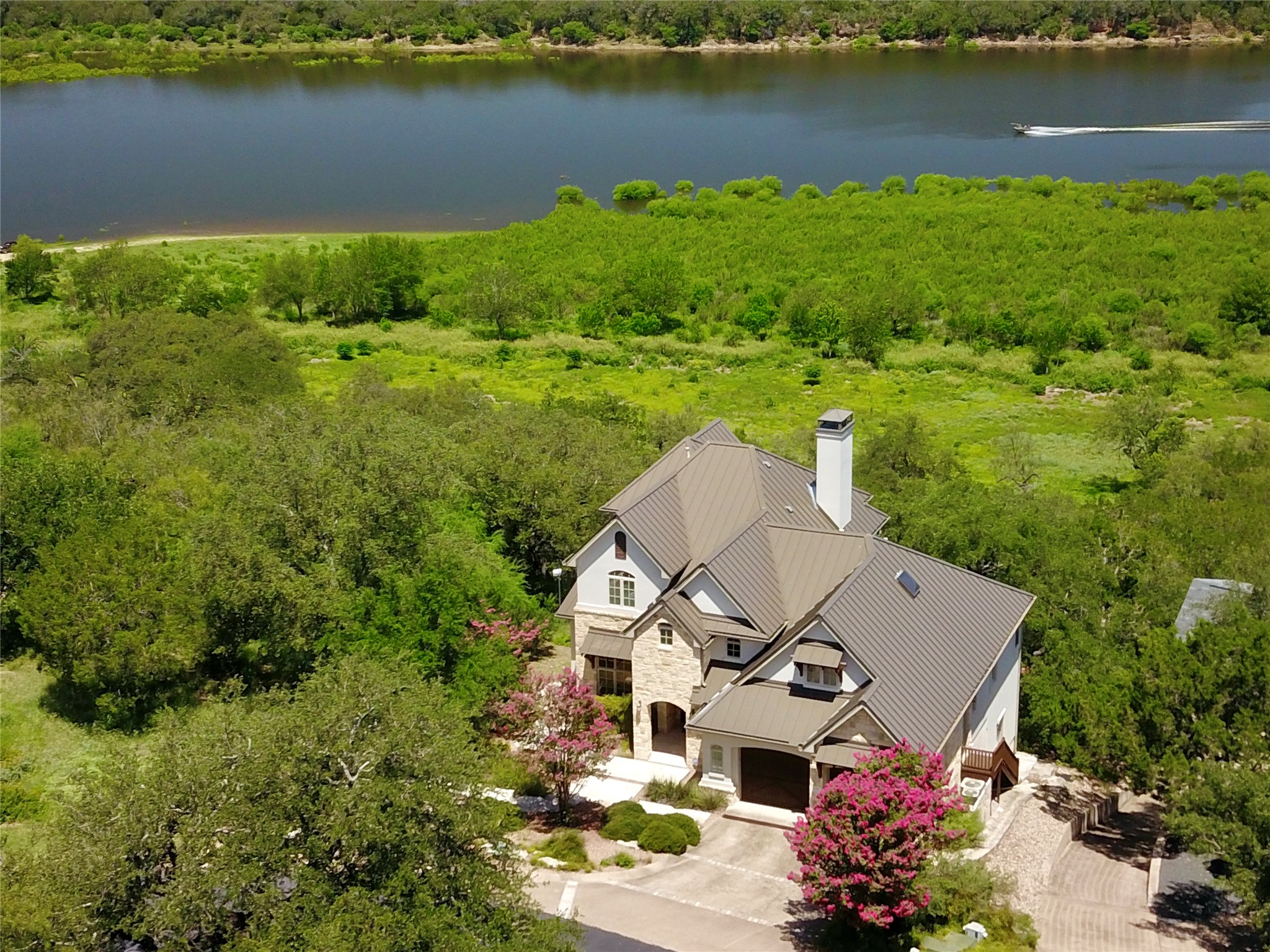 an aerial view of a house with a lake view