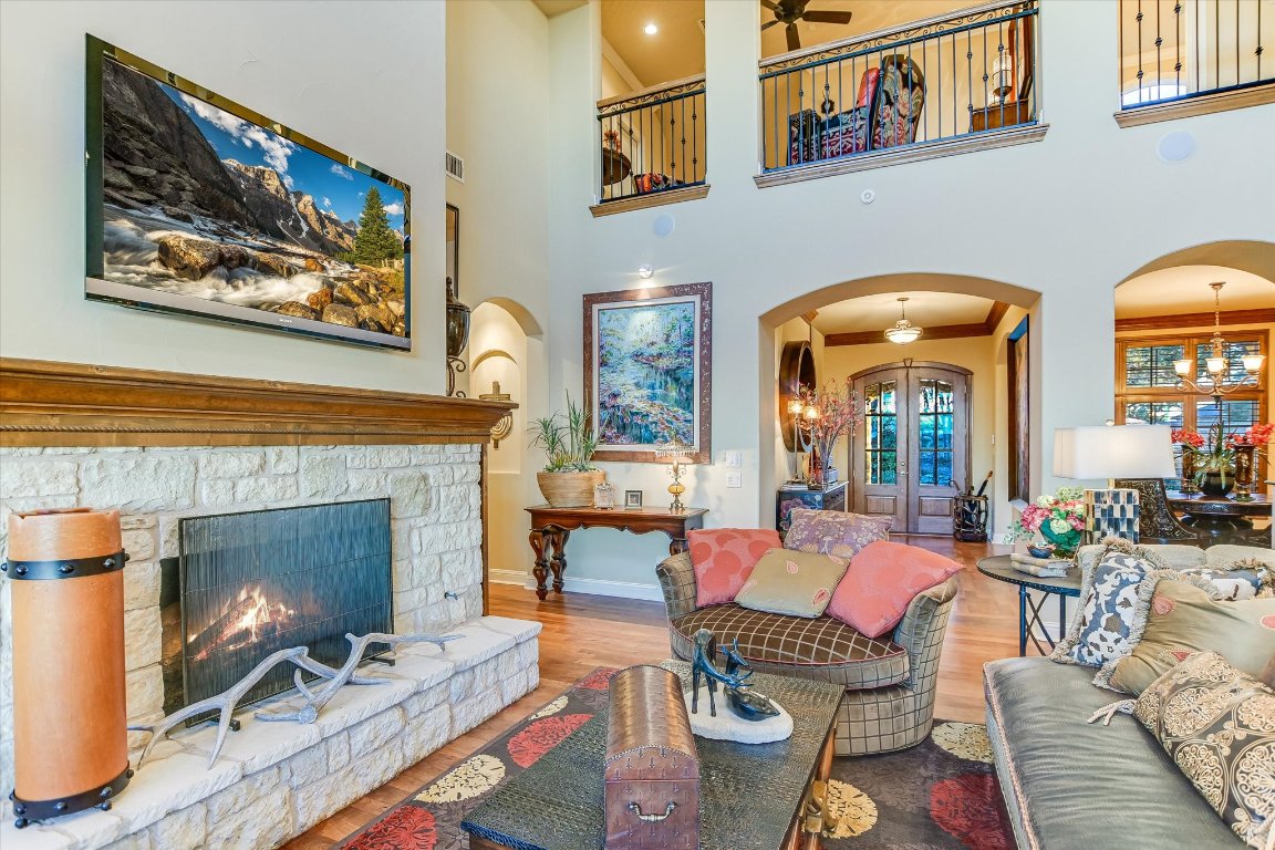 633 Wesley Ridge Drive Spicewood, TX 78669 - Photo 12 of 40 A stone fireplace with gas logs, adds warmth and character to a comfortable living area.