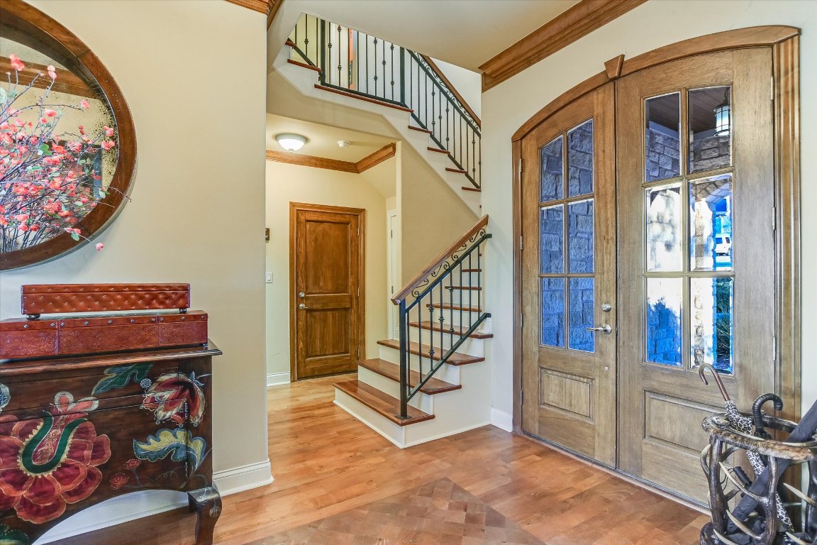 633 Wesley Ridge Drive Spicewood, TX 78669 - Photo 21 of 40 Wrought iron accents highlight the staircase leading to a spacious upper level with a reading nook, media room, and two bedrooms with en-suite baths. One bedroom opens to a private balcony!