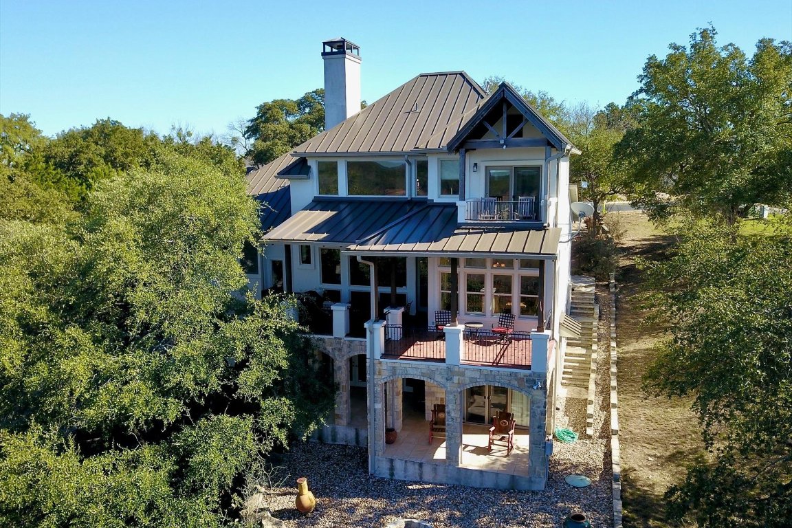 633 Wesley Ridge Drive Spicewood, TX 78669 - Photo 30 of 40 Showcasing multi-level outdoor living, this design maximizes its elevated setting with incredible Lake Travis views.