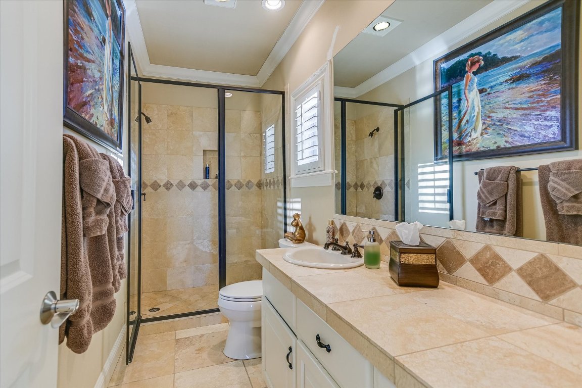 633 Wesley Ridge Drive Spicewood, TX 78669 - Photo 35 of 40 The lower-level full hall bath is conveniently located across from the bedroom for easy access.