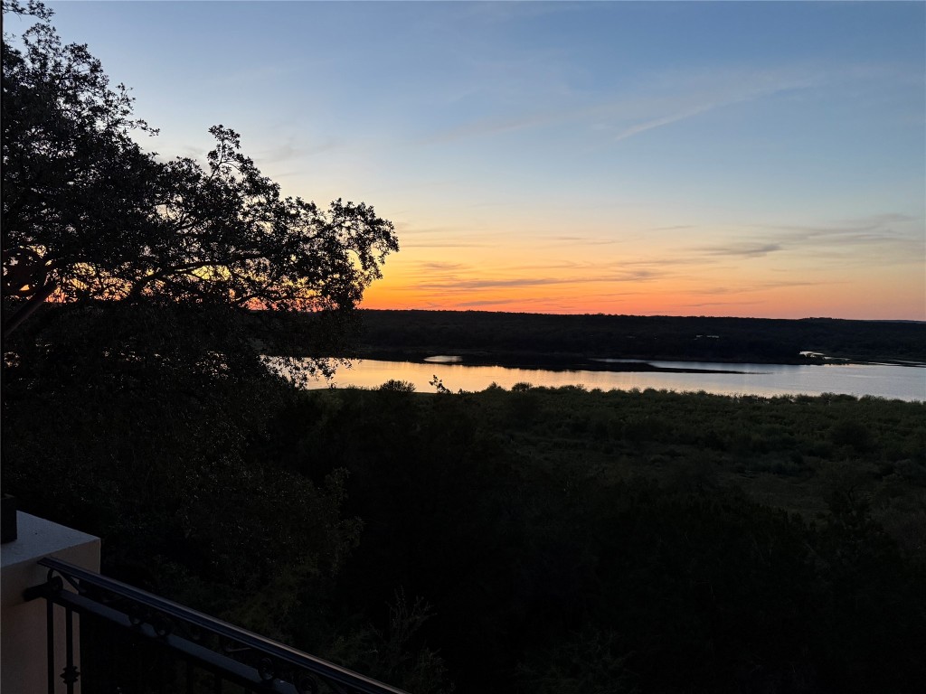 633 Wesley Ridge Drive Spicewood, TX 78669 - Photo 7 of 40 Sweeping twilight views over the Texas Hill Country create a stunning backdrop, blending vibrant skies with natural beauty.