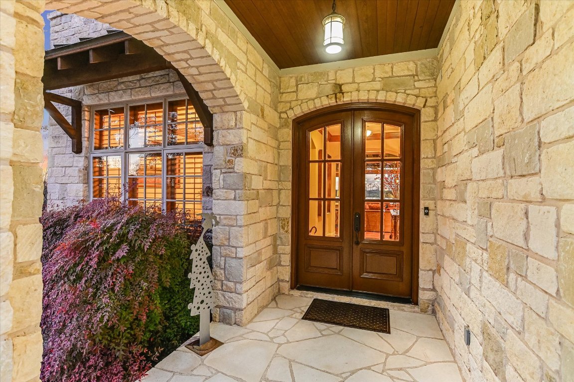 633 Wesley Ridge Drive Spicewood, TX 78669 - Photo 9 of 40 The welcoming entry framed by beautiful stonework and custom double doors, sets the stage for the craftsmanship inside.