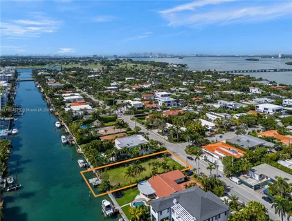 an aerial view of residential houses with outdoor space and river