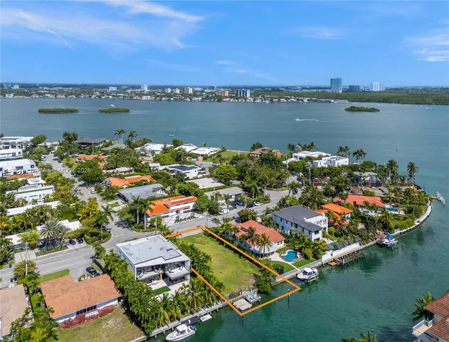 an aerial view of residential houses with outdoor space and lake view