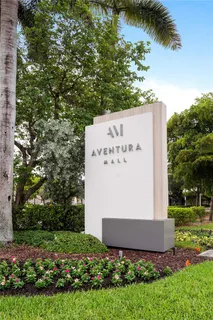 front view of a house with a yard and potted plants