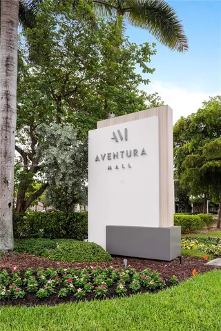 front view of a house with a yard and potted plants